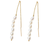 Pair of pearl drop earrings with gold chains on a white background