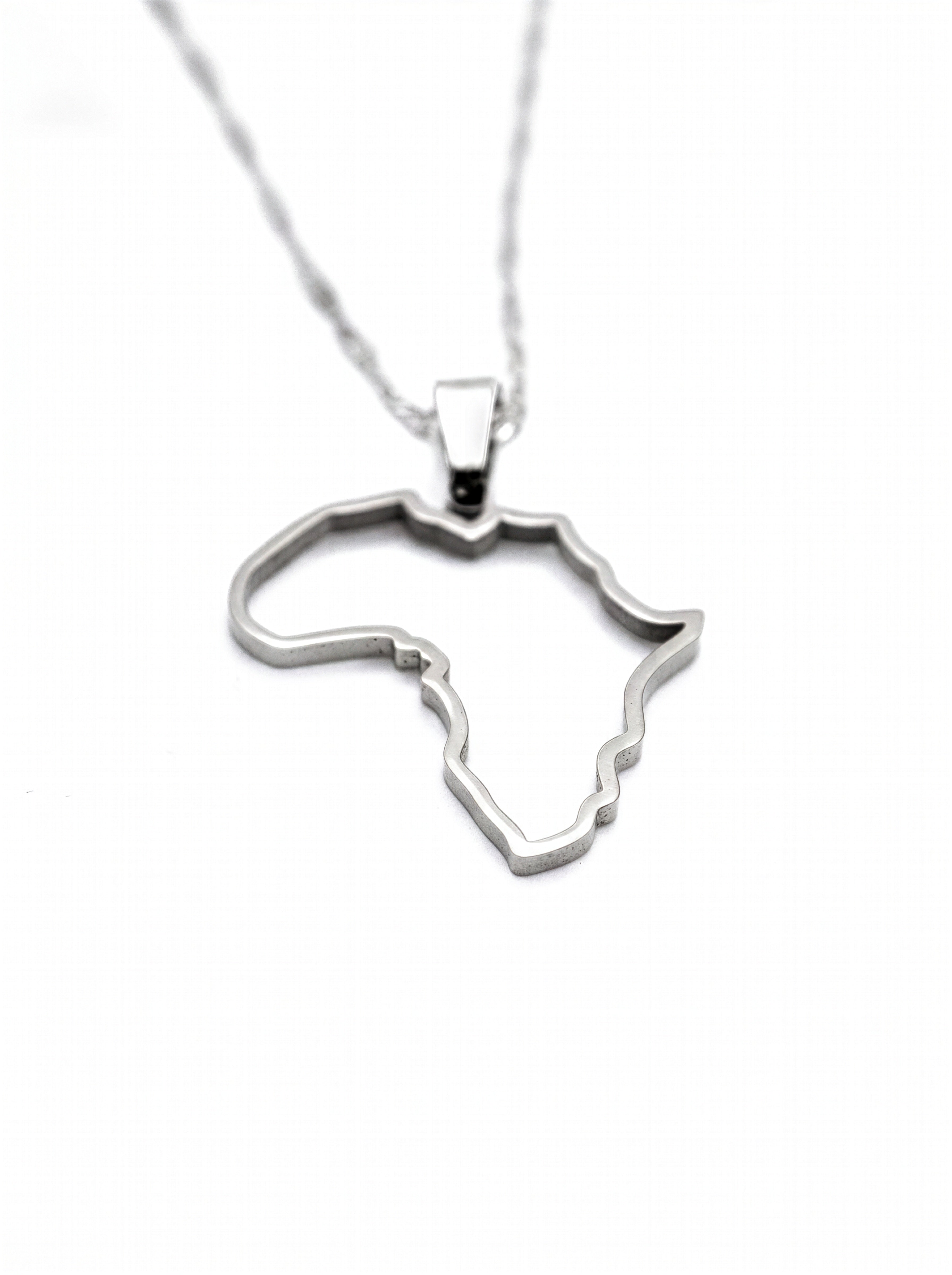 Gold Africa map outline necklace on a chain from KIRO UK celebrating African heritage with a polished pendant design