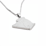 Silver plated Algeria map pendant necklace on a fine chain shown against a white background with a raised outline design for heritage inspired style