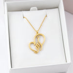 Gold plated necklace featuring Arabic calligraphy for My Mother in a heart shaped pendant displayed in a white jewellery box by KIRO UK