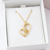 Gold plated necklace featuring Arabic calligraphy for My Mother in a heart shaped pendant displayed in a white jewellery box by KIRO UK