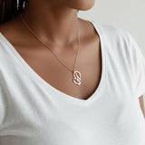 KIRO UK gold plated Arabic calligraphy necklace featuring a My Mother pendant in a decorative heart shape worn on a woman in a white top