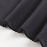 Close up of black cotton T shirt hem with neat double stitching and soft folded fabric detail from KIRO Clothing