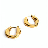 Pair of chunky oval 18K gold plated hoop earrings by KIRO UK on a white background with a smooth polished finish and secure hinged closures