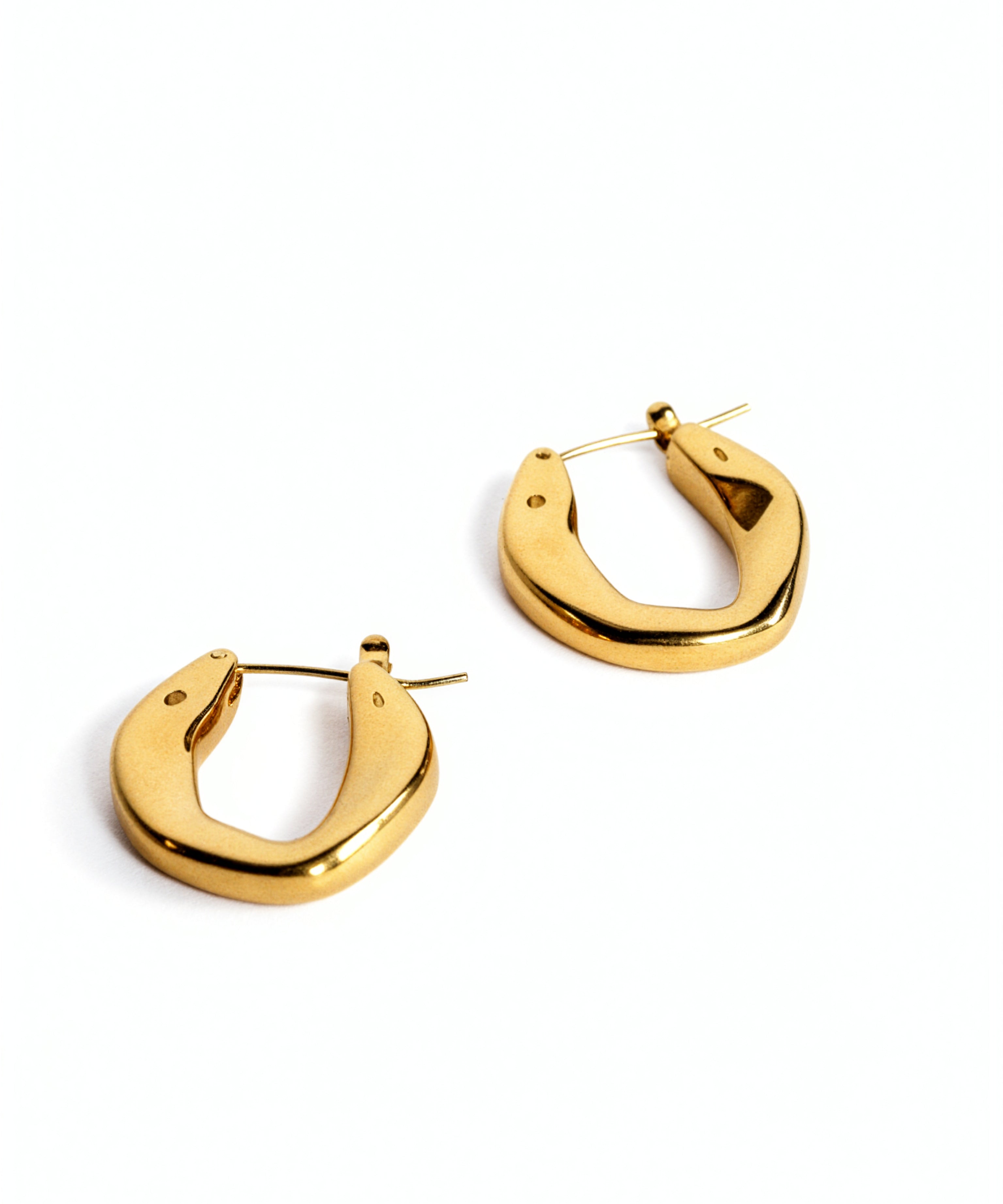 Pair of chunky oval 18K gold plated hoop earrings by KIRO UK on a white background with a smooth polished finish and secure hinged closures
