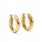 Pair of 18K gold plated oval hoop earrings from KIRO UK with a smooth chunky statement design on a white background