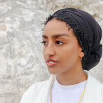 Woman wearing a gold plated statement necklace from KIRO UK Egyptian Collection with a smooth collar design and polished finish layered over a white top