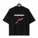 Black oversized cotton T shirt on a hanger with Egypt crossed out in white and red Arabic Masr lettering below from KIRO Clothing