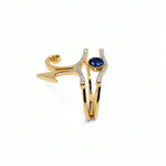 KIRO UK gold vermeil Eye of Horus ring set with cubic zirconia and a central blue sapphire, shown as two stackable rings from the Egyptian Collection