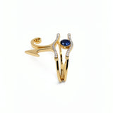 KIRO UK gold vermeil Eye of Horus ring set with cubic zirconia and a central blue sapphire, shown as two stackable rings from the Egyptian Collection