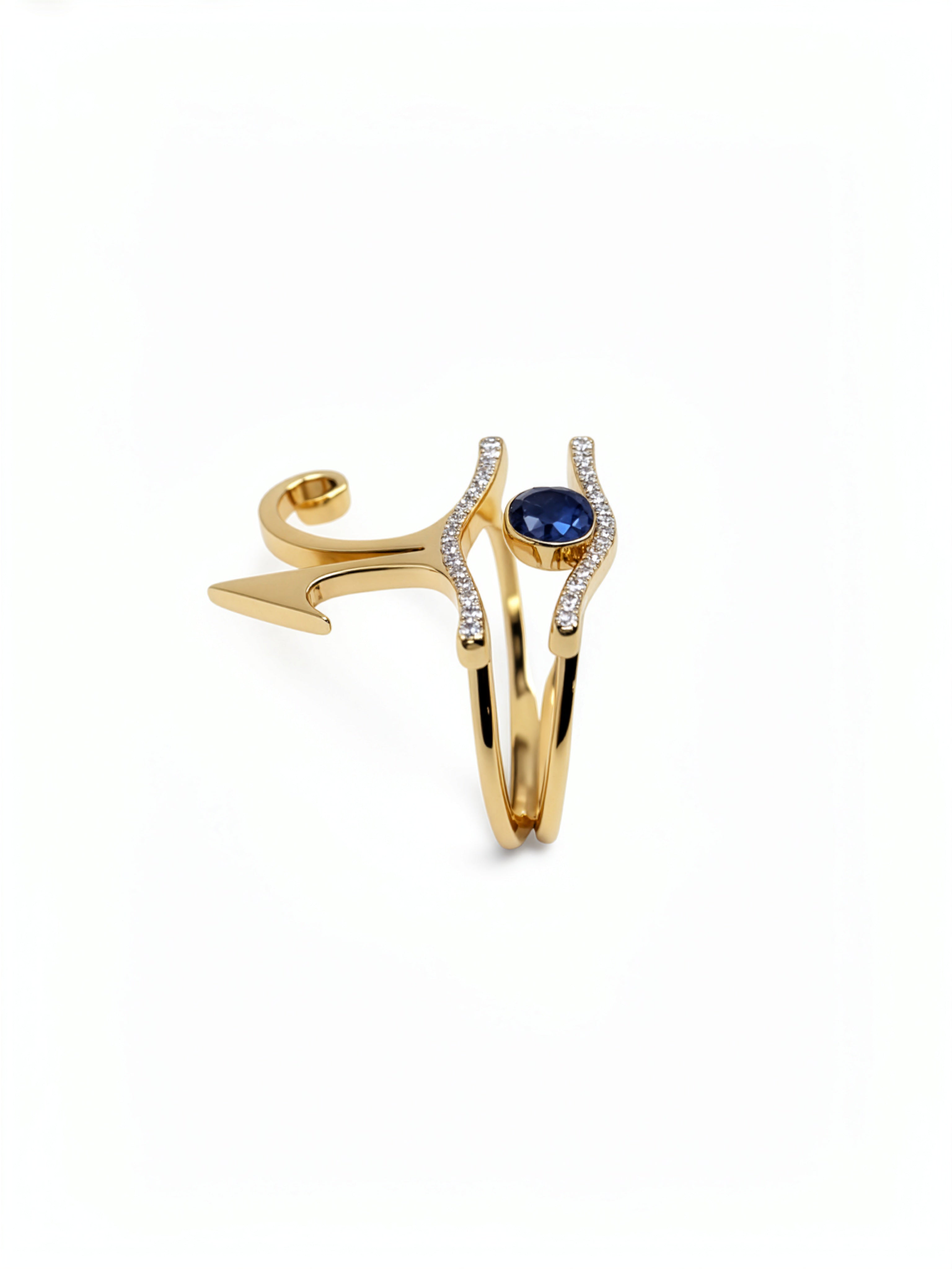 KIRO UK gold vermeil Eye of Horus ring set with cubic zirconia and a central blue sapphire, shown as two stackable rings from the Egyptian Collection