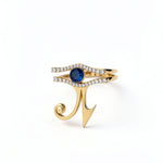 KIRO UK Eye of Horus ring with two stackable gold vermeil bands lined with cubic zirconia and a central blue sapphire on white background