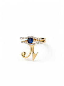 KIRO UK Eye of Horus ring with two stackable gold vermeil bands lined with cubic zirconia and a central blue sapphire on white background