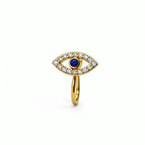 Gold faux nose cuff featuring an evil eye design with a blue sapphire centerpiece and surrounding cubic zirconia gems on a white background