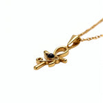 KIRO gold Ankh Horus fusion pendant necklace with a central black gemstone on a delicate chain