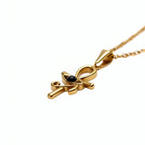 KIRO gold Ankh Horus fusion pendant necklace with a central black gemstone on a delicate chain
