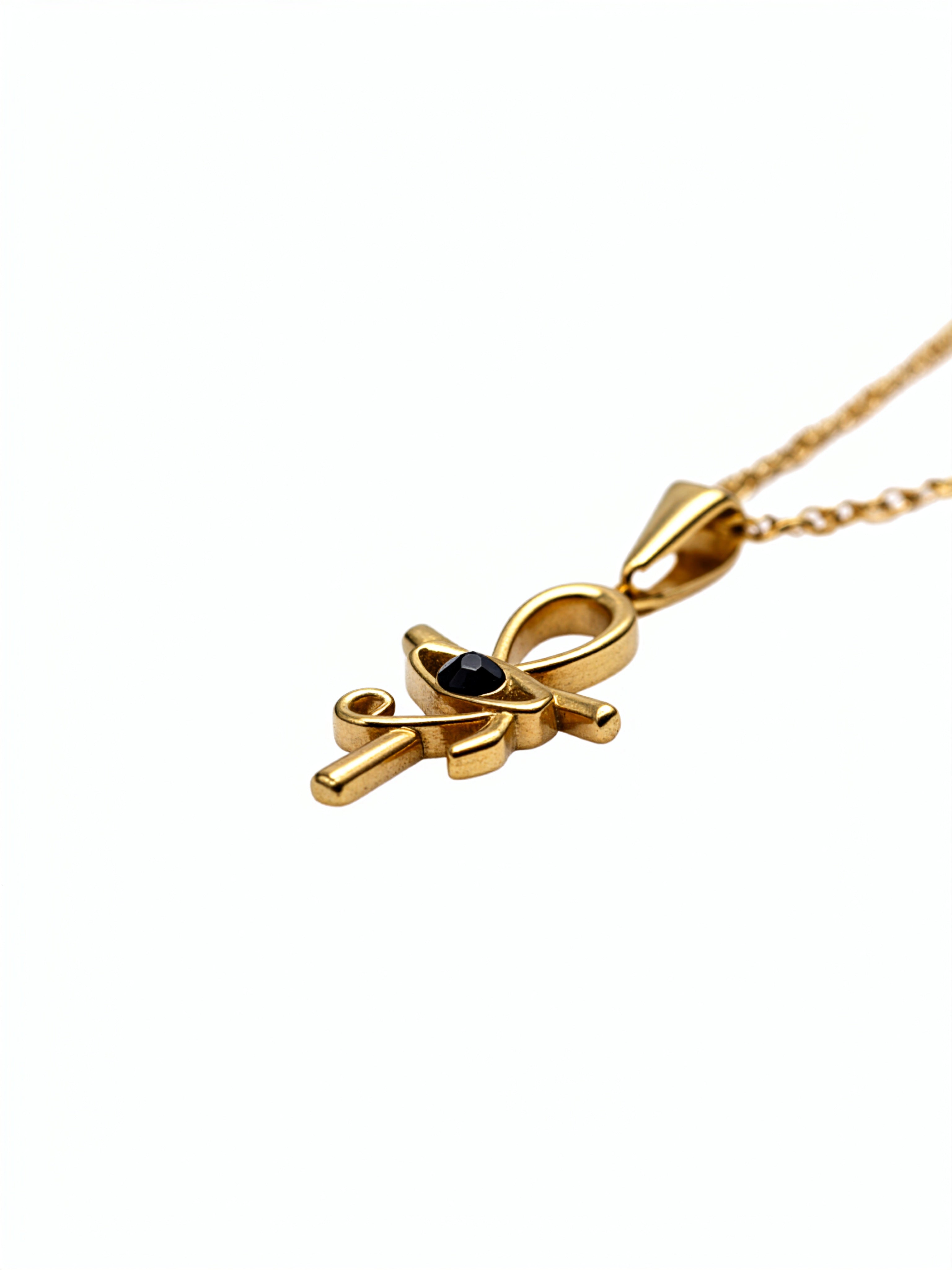 KIRO gold Ankh Horus fusion pendant necklace with a central black gemstone on a delicate chain