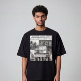 A model wears a black cotton T shirt by KIRO from Clothing featuring an Egyptian collage with a felucca Queen Nefertiti banknote postal stamp and 6 October War headline