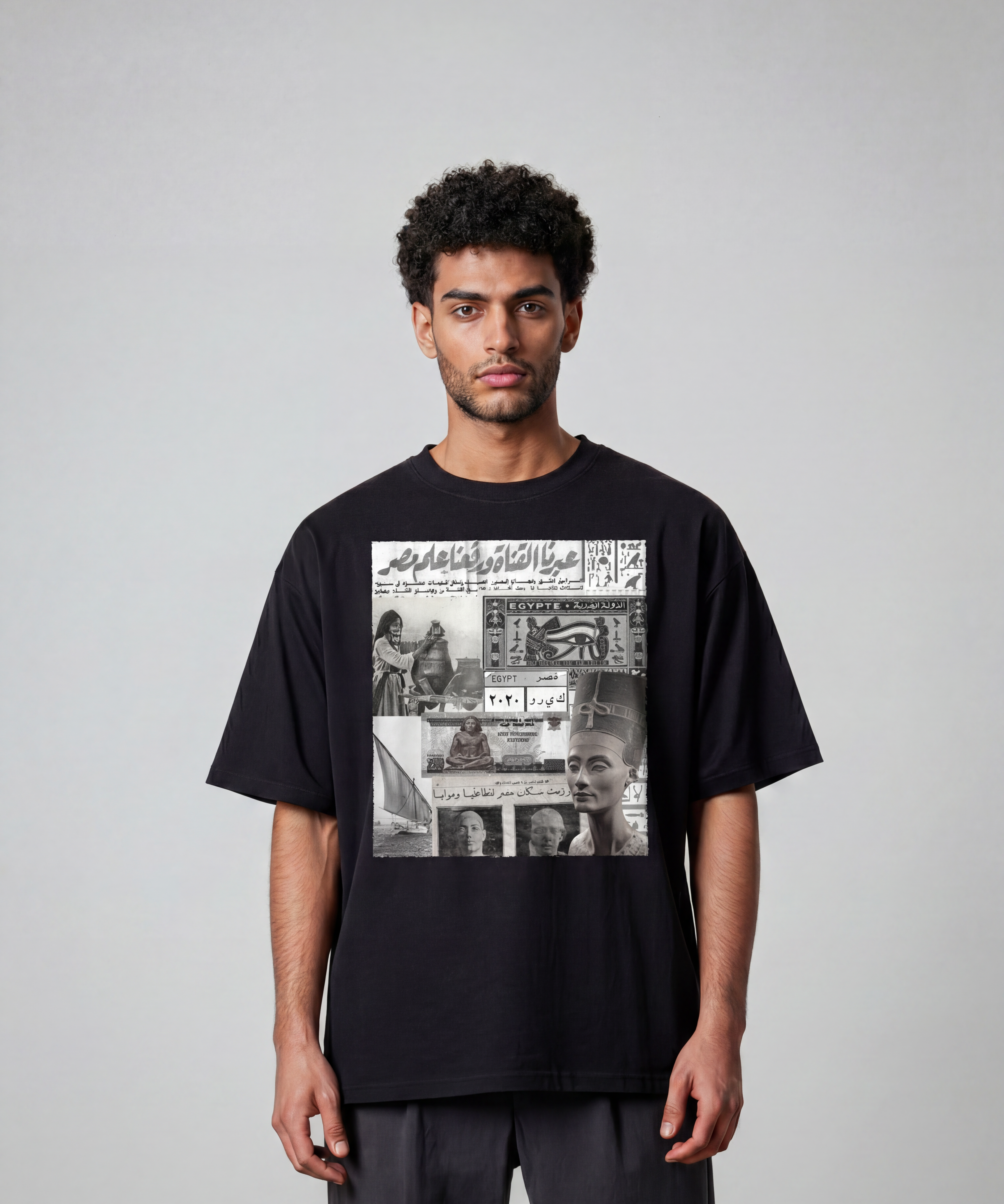 A model wears a black cotton T shirt by KIRO from Clothing featuring an Egyptian collage with a felucca Queen Nefertiti banknote postal stamp and 6 October War headline