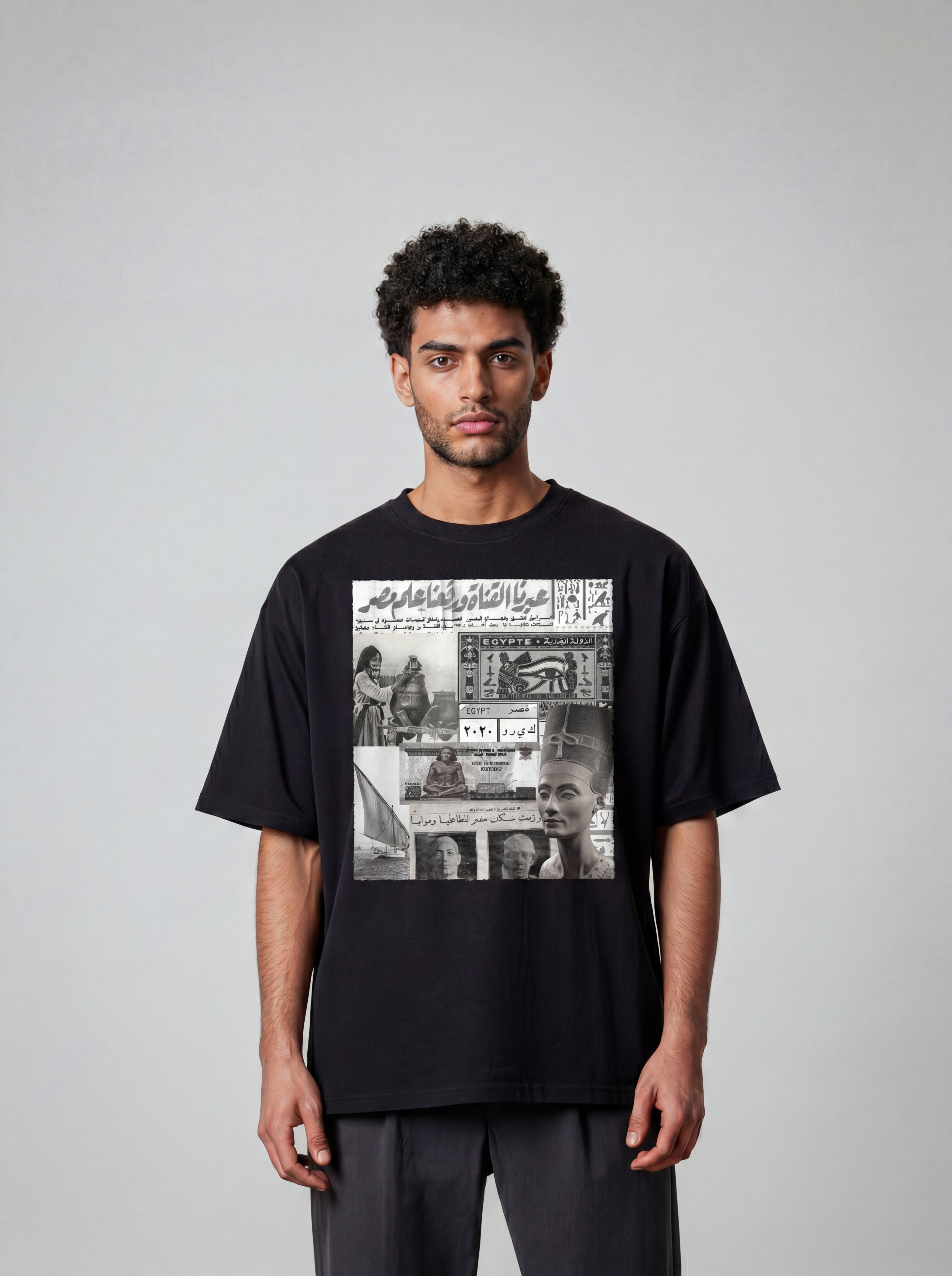 A model wears a black cotton T shirt by KIRO from Clothing featuring an Egyptian collage with a felucca Queen Nefertiti banknote postal stamp and 6 October War headline