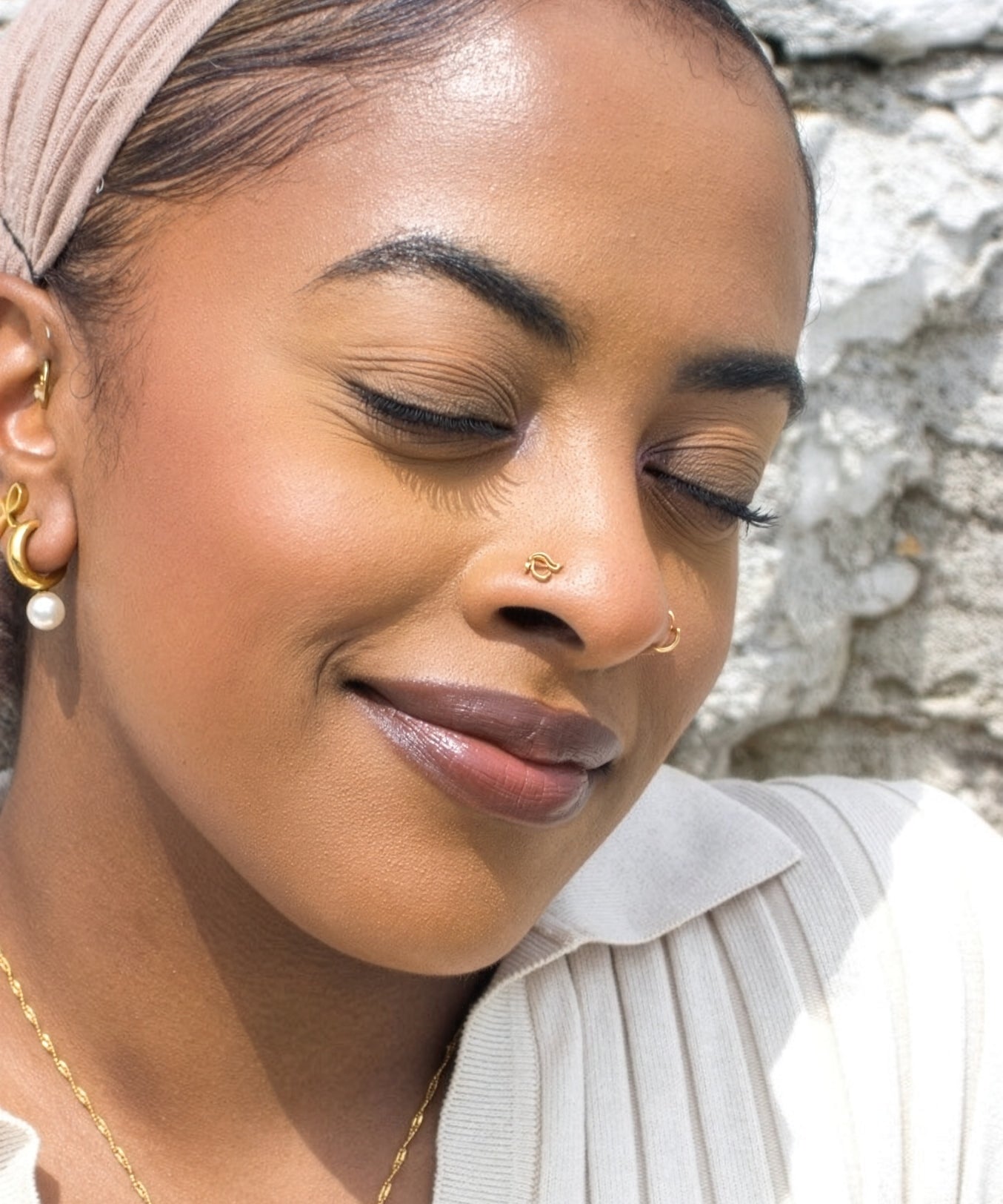 Close up portrait of a woman wearing a gold Eye of Horus nose stud by KIRO UK inspired by Egyptian heritage