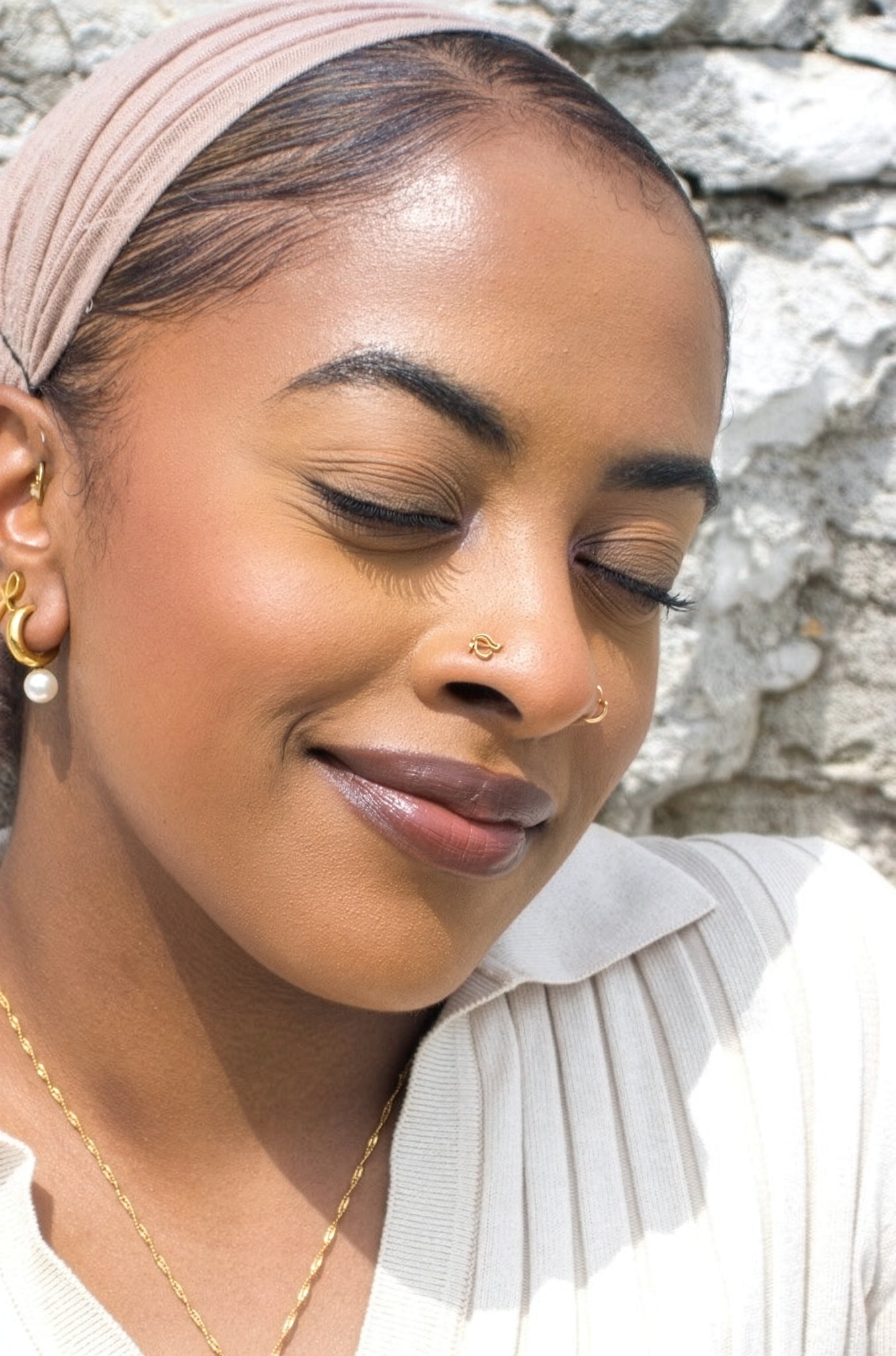 Close up portrait of a woman wearing a gold Eye of Horus nose stud by KIRO UK inspired by Egyptian heritage