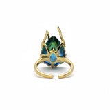 KIRO Amarna ring with a large, faceted blue-green cubic zirconia gemstone set in 18K gold plated metal. Resizeable.