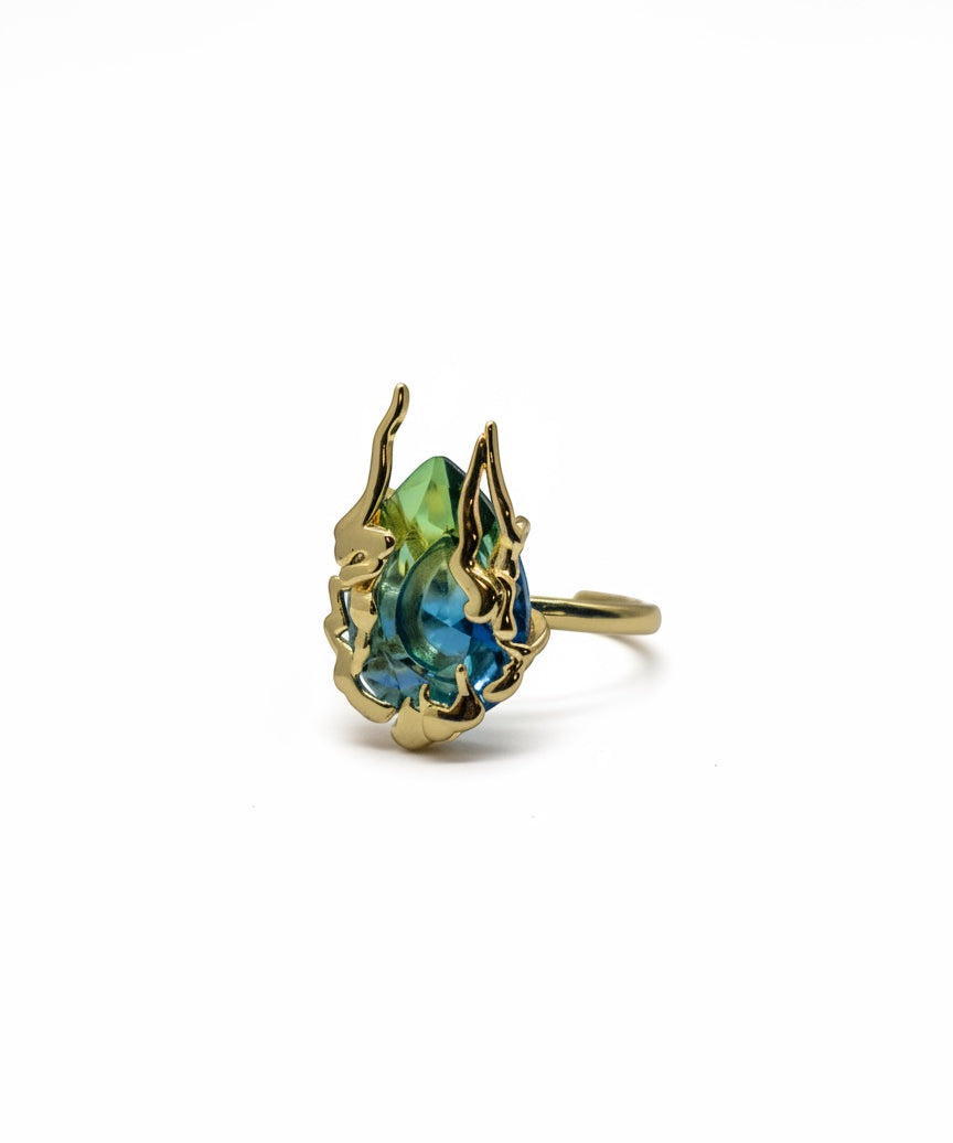 KIRO Amarna Ring with a blue-green cubic zirconia gemstone set in 18K gold plated metal. Resizeable.