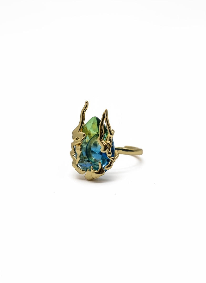 KIRO Amarna Ring with a blue-green cubic zirconia gemstone set in 18K gold plated metal. Resizeable.