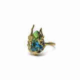 KIRO Amarna Ring with a blue-green cubic zirconia gemstone set in 18K gold plated metal. Resizeable.
