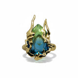 KIRO Amarna ring with a large, faceted blue-green cubic zirconia gemstone set in 18K gold plated metal. Resizeable.