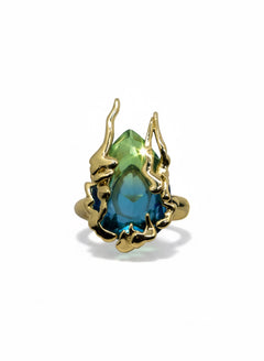 KIRO Amarna ring with a large, faceted blue-green cubic zirconia gemstone set in 18K gold plated metal. Resizeable.