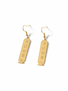 KIRO gold plated stainless steel drop earrings featuring engraved Egyptian hieroglyphs in an oval cartouche design.