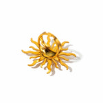 KIRO gold ring in the shape of a sun shining with several large rays and small rays. The ring is adjustable to size.