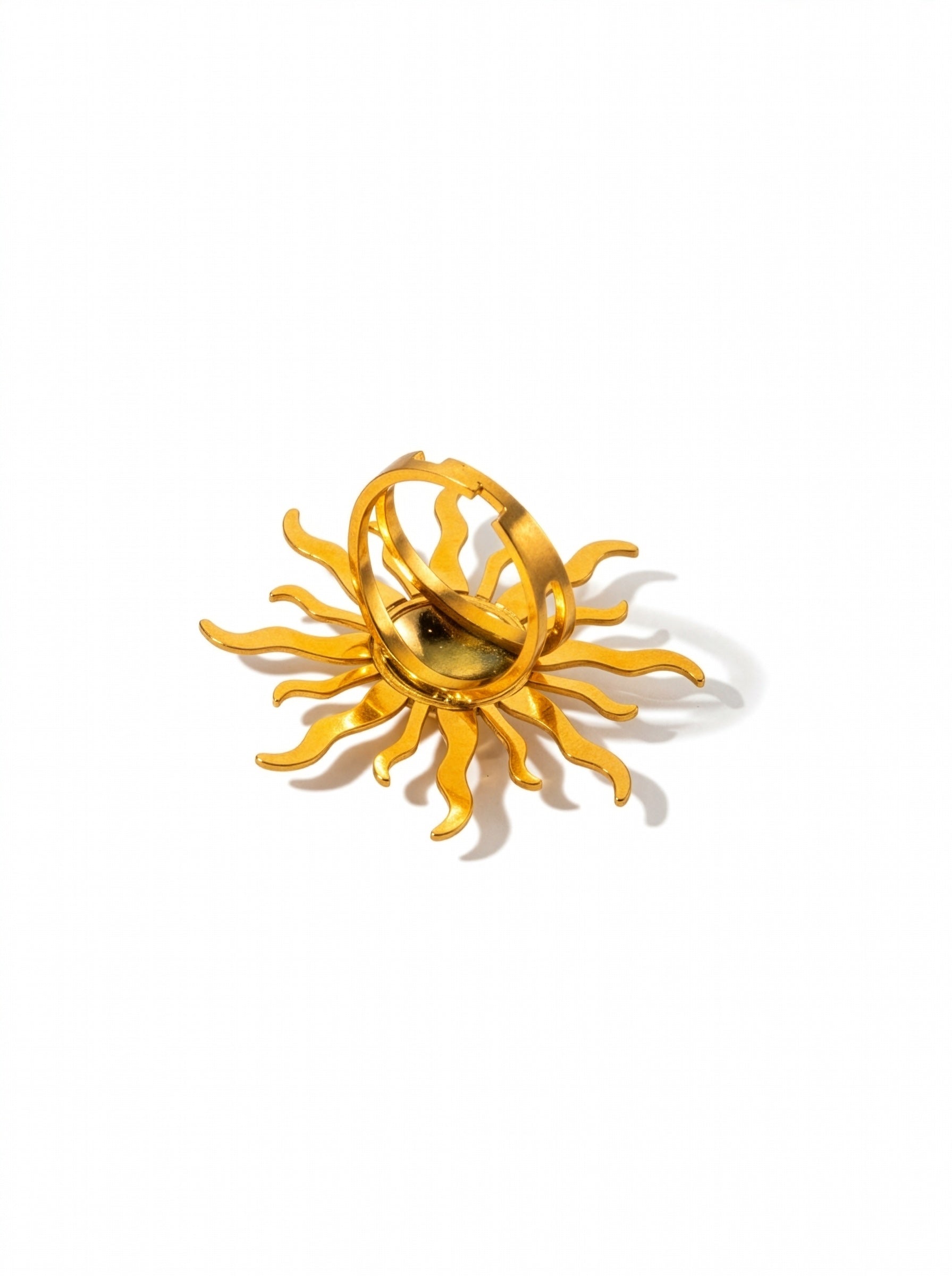 KIRO gold ring in the shape of a sun shining with several large rays and small rays. The ring is adjustable to size.