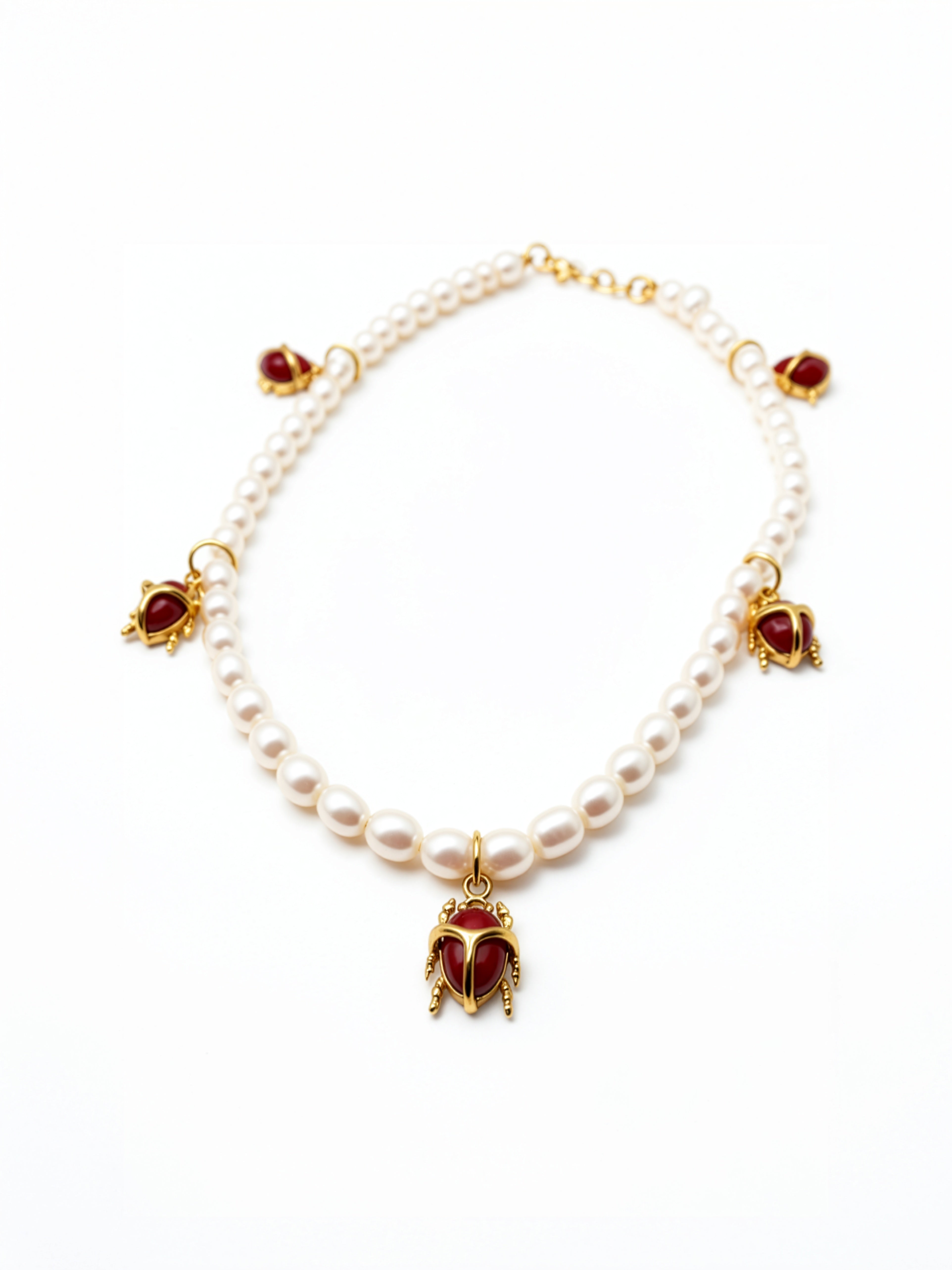 KIRO Scarab Pearl Necklace featuring ivory freshwater pearls and five 18k gold-plated scarab charms with carnelian stones.