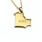 Gold plated map necklace pendant shaped like Mauritania with KIRO engraved on the front and a textured chain on a white background
