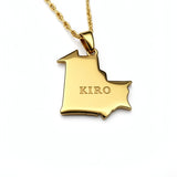 Gold plated map necklace pendant shaped like Mauritania with KIRO engraved on the front and a textured chain on a white background