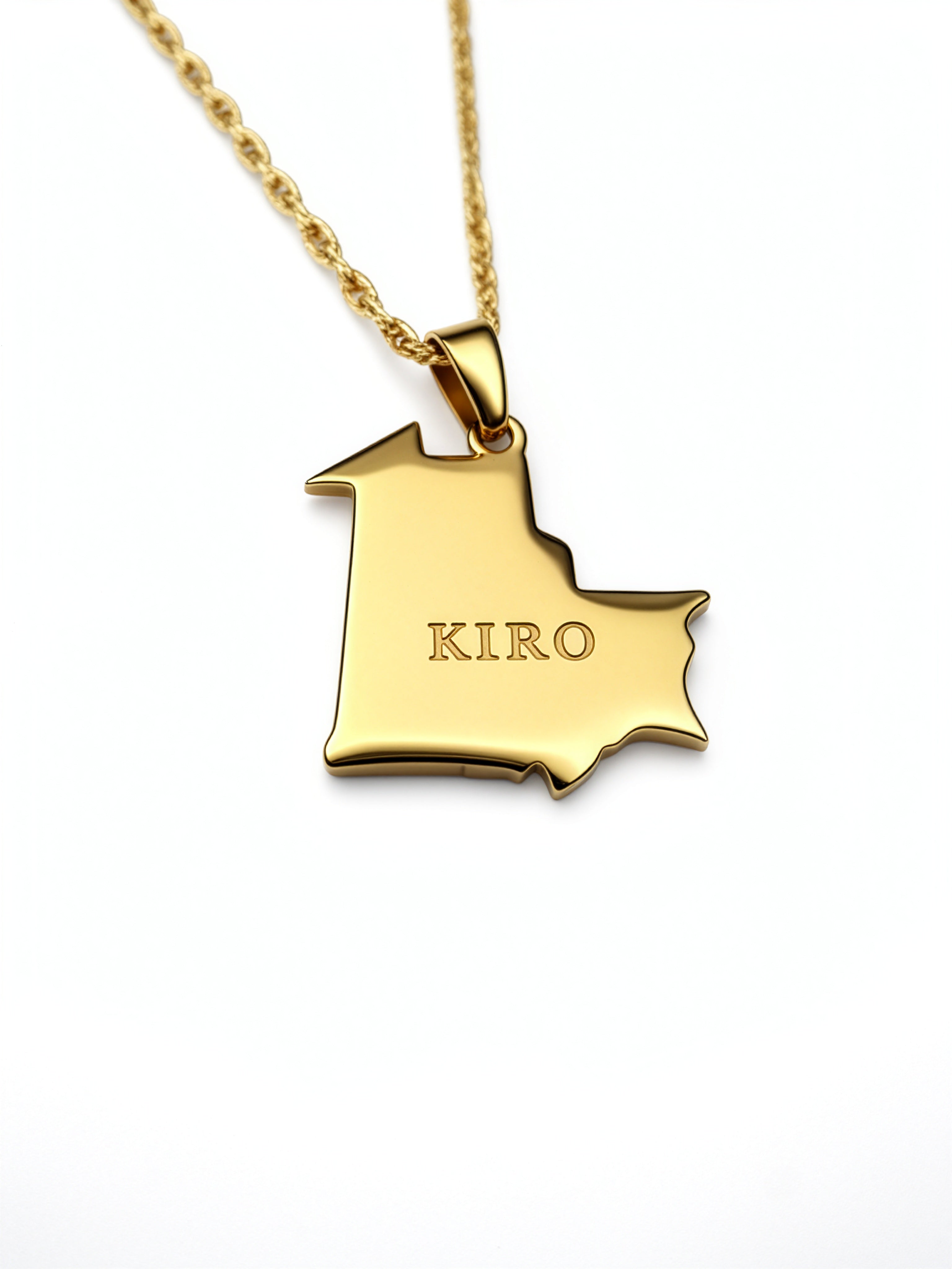 Gold plated map necklace pendant shaped like Mauritania with KIRO engraved on the front and a textured chain on a white background