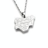 silver necklace of the map of Nigeria. "Nigeria" is written in the middle with all the cities engraved. the pendant hangs on a water wave chain.