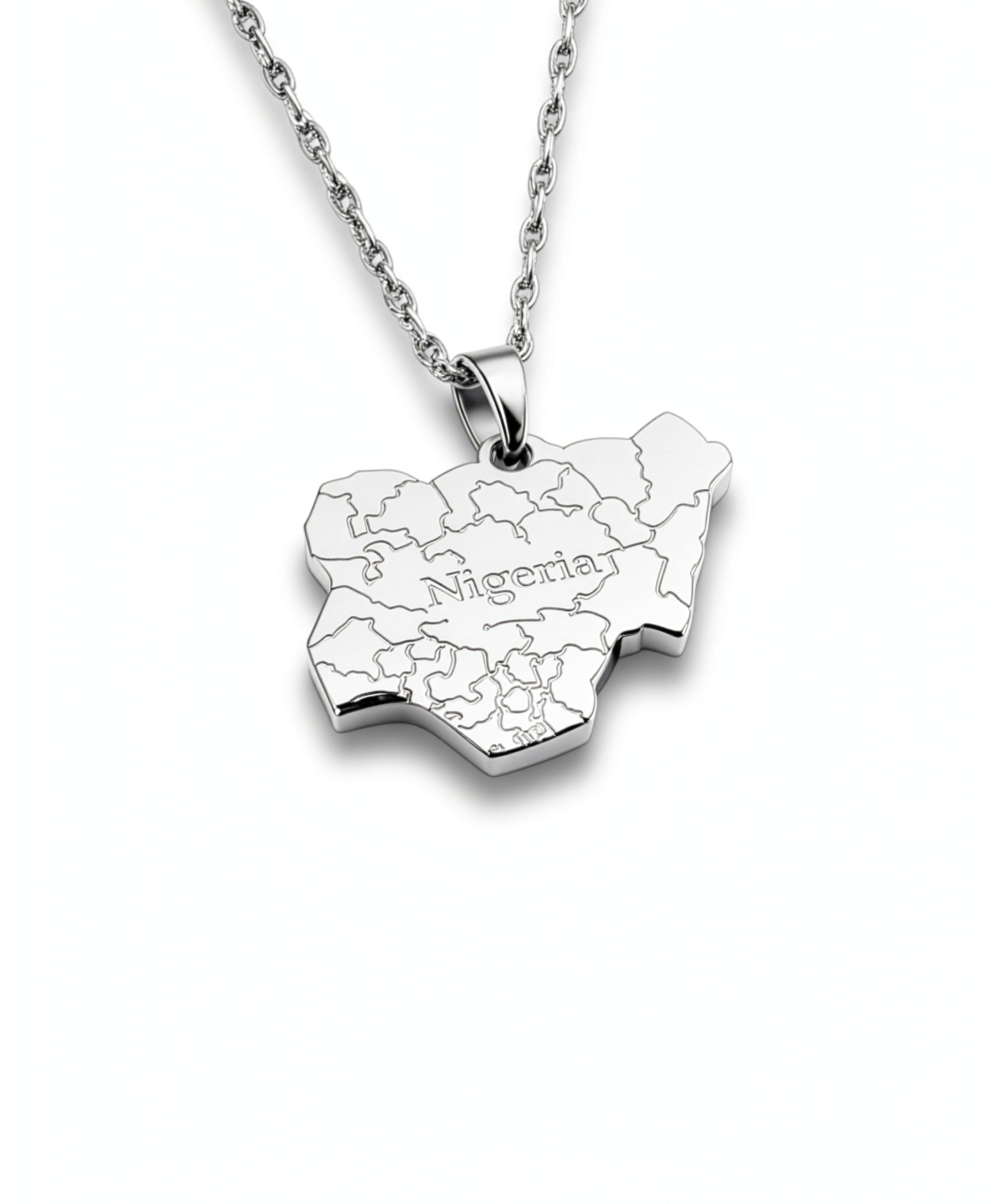 silver necklace of the map of Nigeria. "Nigeria" is written in the middle with all the cities engraved. the pendant hangs on a water wave chain.