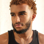 A man wearing a silver plated Nubia map necklace with a small engraved map pendant celebrating Nubian heritage by KIRO UK