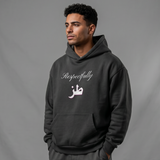 Male model wearing a black oversized cotton hoodie with an extra large hood and Arabic lettering beneath Respectfully print from KIRO Clothing