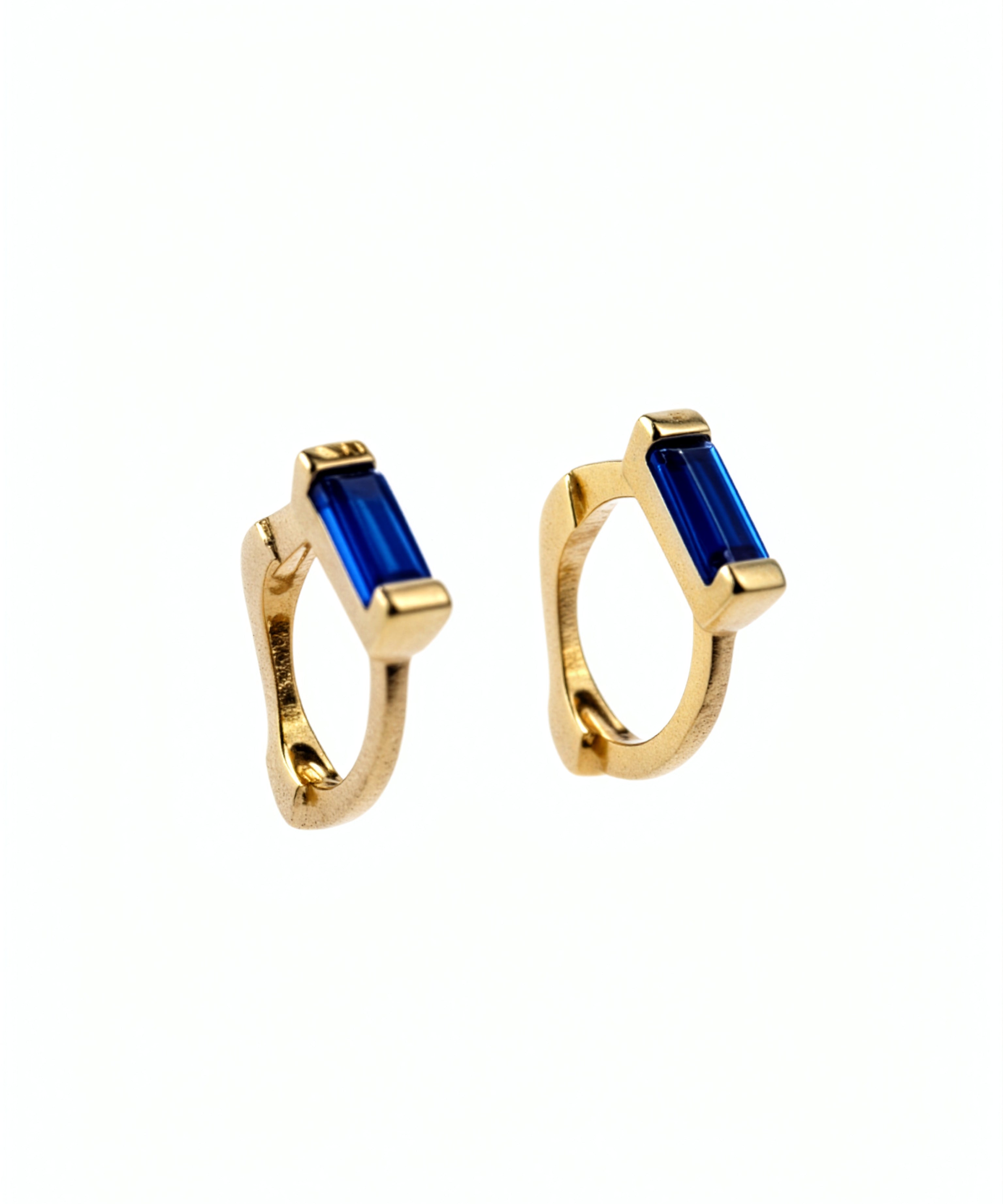 Gold vermeil huggie earrings with blue sapphire accents from KIRO UK featured in the Earrings Winter Edit and Gemstone Edit collections