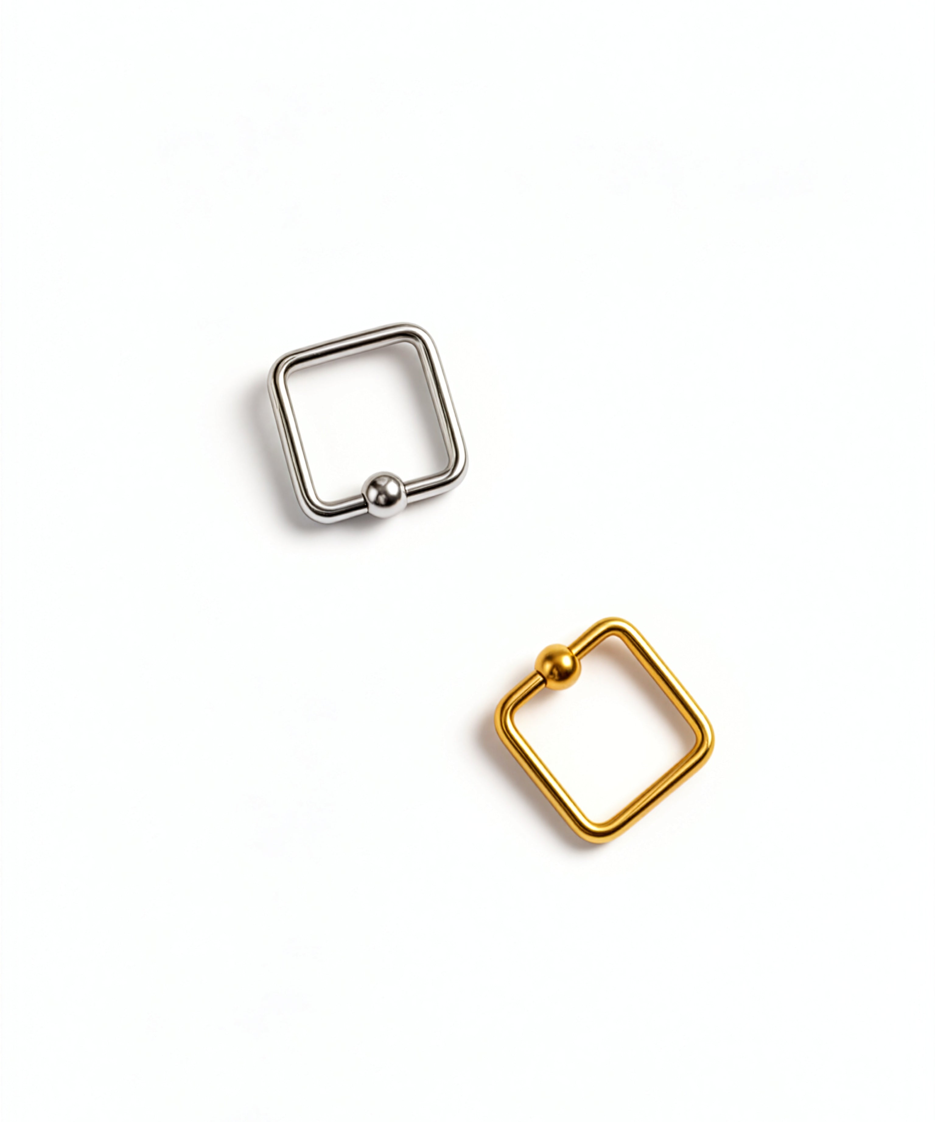 Gold and silver square septum rings set of two by KIRO UK with geometric edges and ball closures on a white background