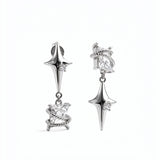 KIRO UK Earrings featuring silver plated star drop earrings with clear cubic zirconia accents and ornate sculpted lower charms on a white background