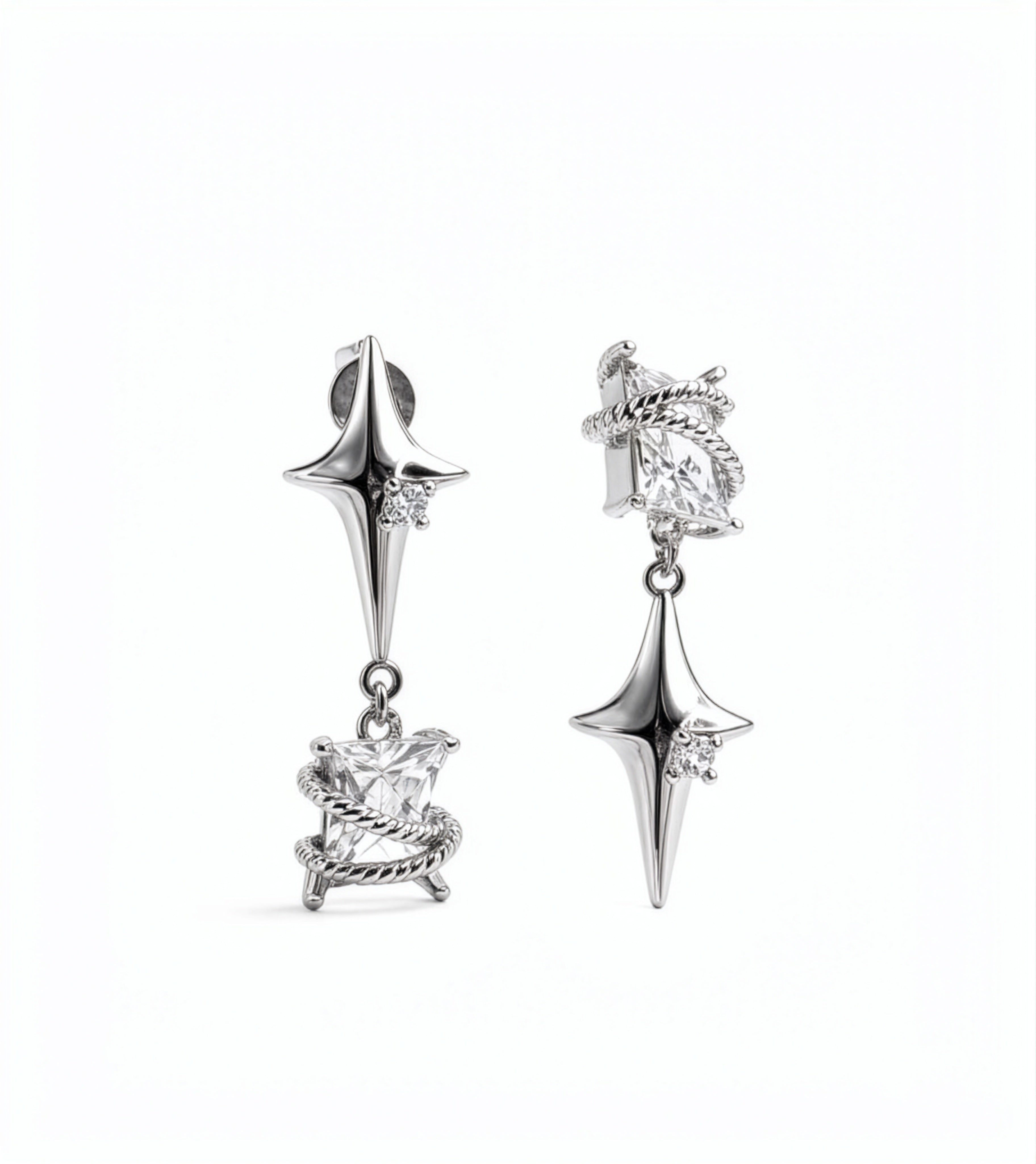 KIRO UK Earrings featuring silver plated star drop earrings with clear cubic zirconia accents and ornate sculpted lower charms on a white background