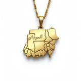 Gold plated Sudan map necklace with Arabic engraving on the pendant and a linked chain by KIRO UK on a white background