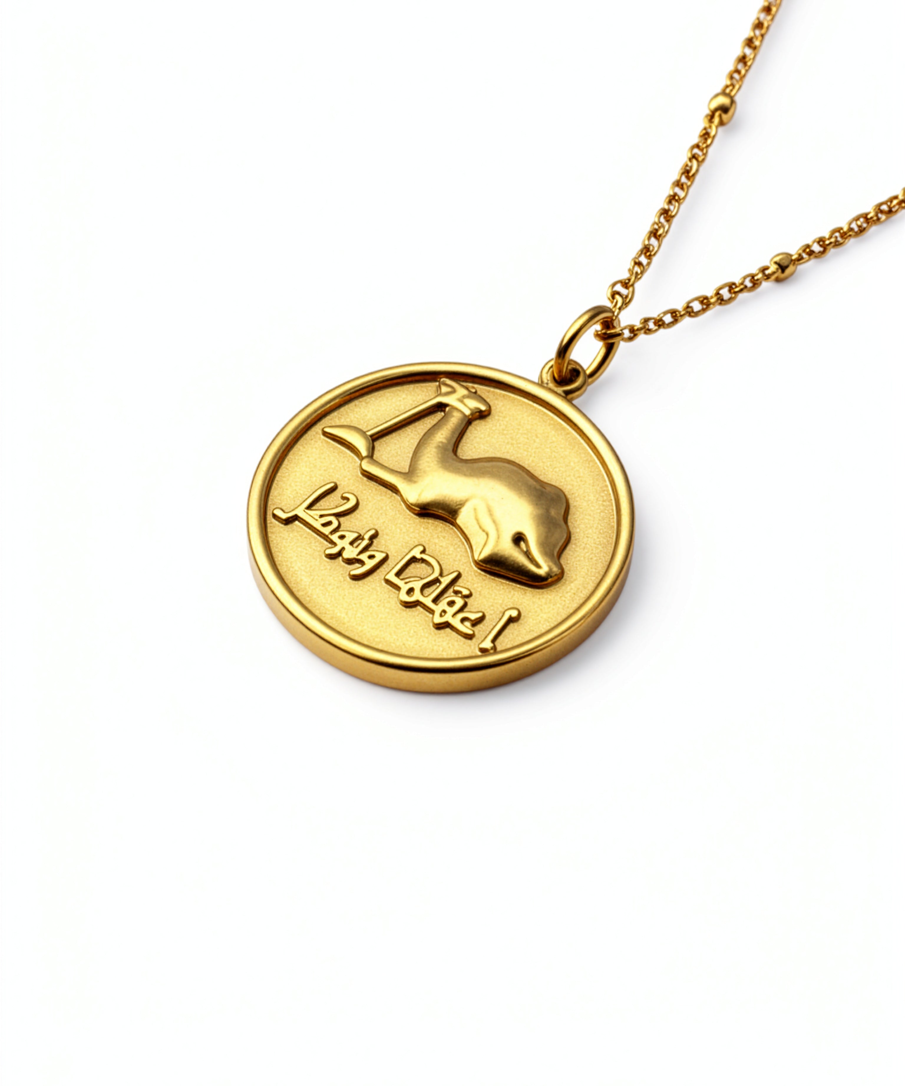 Gold camel coin necklace with raised camel design and Arabic inscription on a chain from KIRO UK Statement Pieces Best Deals Necklaces