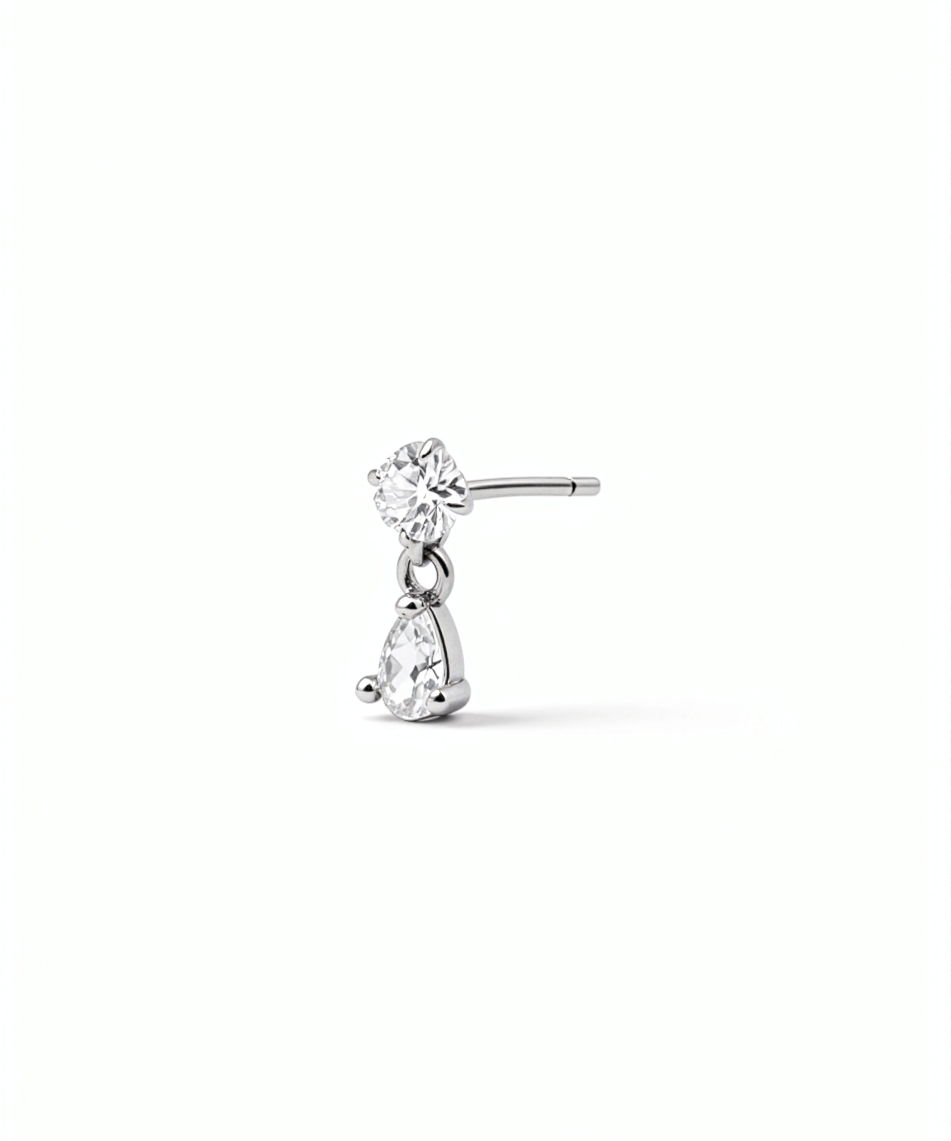 Clear and silver sterling silver L shaped nose stud with a sparkling teardrop charm by KIRO UK from the Nose Ring Winter Edit collection